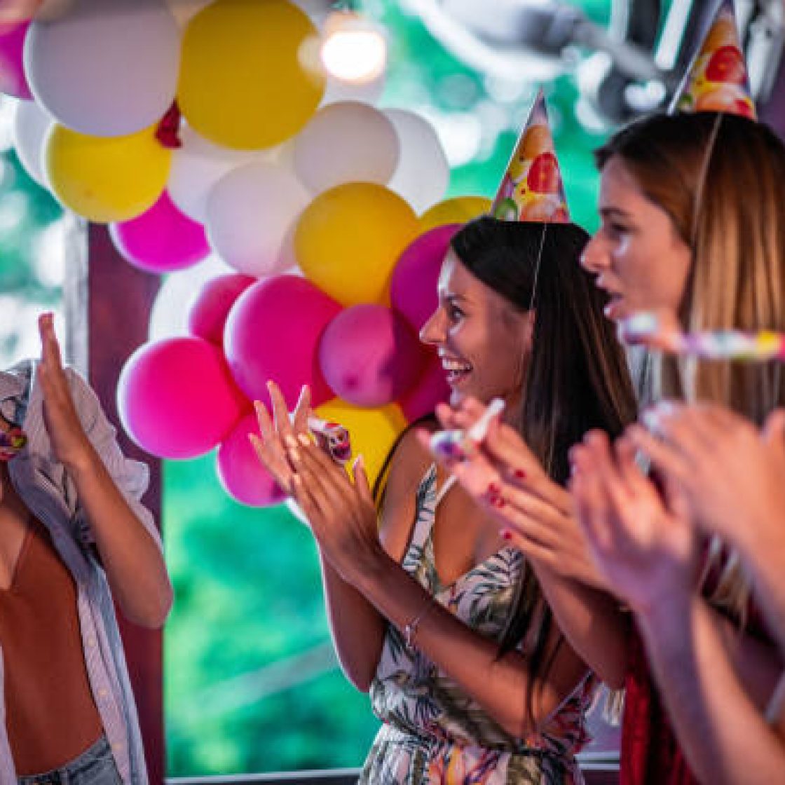 Group of friends celebrating birthday party together outdoors. Concept of celebrating and happiness.
