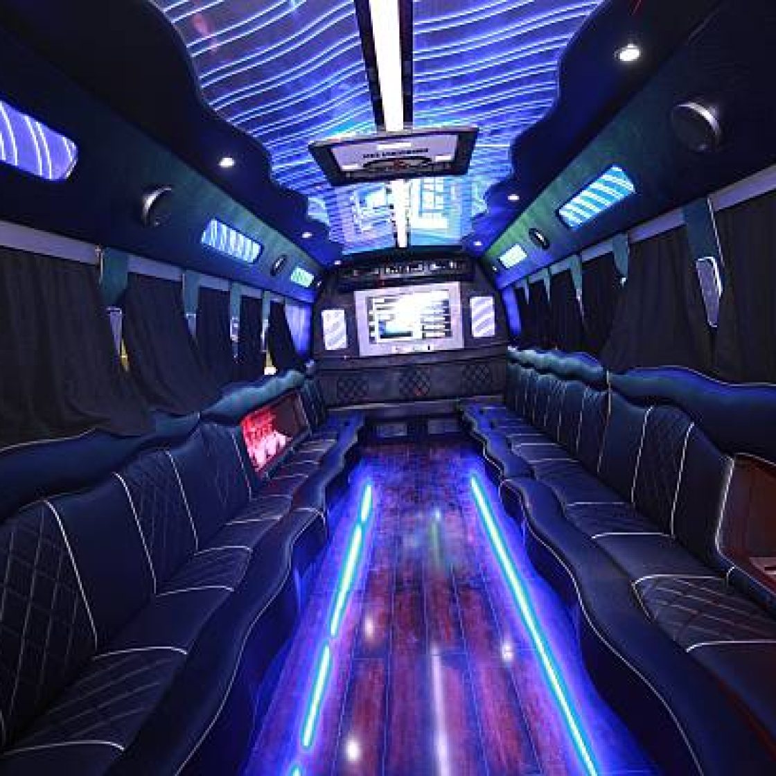A big party bus filled with comfortable seats, and shiny bright floor for dancing and having fun.